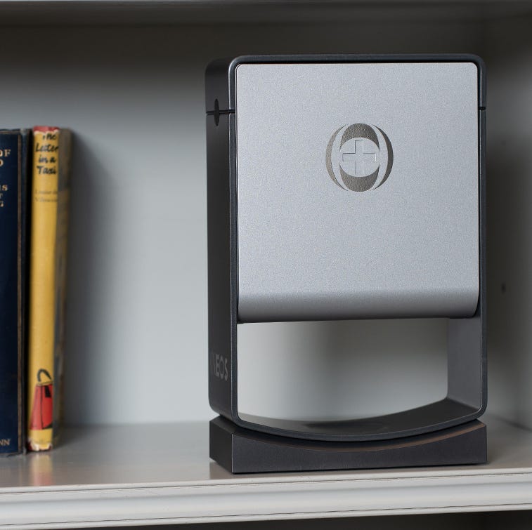 a photo of a ineos hygienics hand sanitiser dispenser on a bookshelf