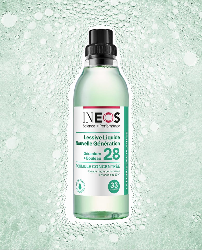 a photo of the french version of the bergamot and cedarwood laundry liquid on a green bubbly background