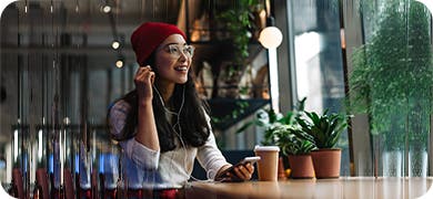 Image of a modern woman wearing a red beanie to signify cultural trends.
