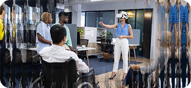 Image of a group of agency people watching a female with a VR headset.