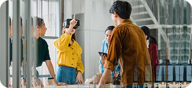 Image depicting a group of people with one person using a VR headset.