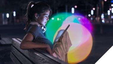 Image: Woman paying focused attention while browsing on her mobile device, emphasizing the significance of attention metrics in advertising and marketing strategies.