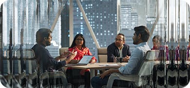 Image depicting five people in a meeting to discuss governance and skills.