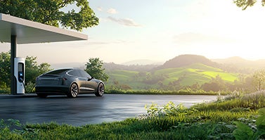 Image of an electric car being charged and showing the hills