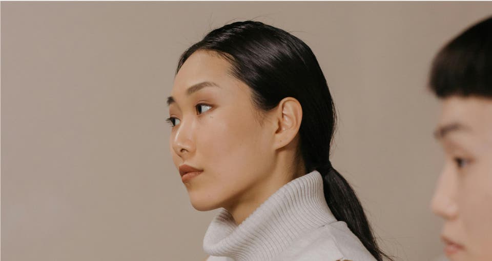 Image: Visionary Leader Archetype: Affluent Female Executives in Beige Background, Gazing Ahead