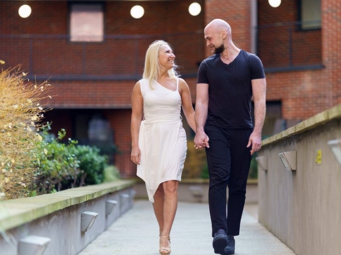 Domnita and Behjet walk hand in hand through the communal gardens at SNG's Evolution development.