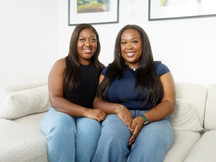 Baaba and Josephine pose for a photo together on the sofa