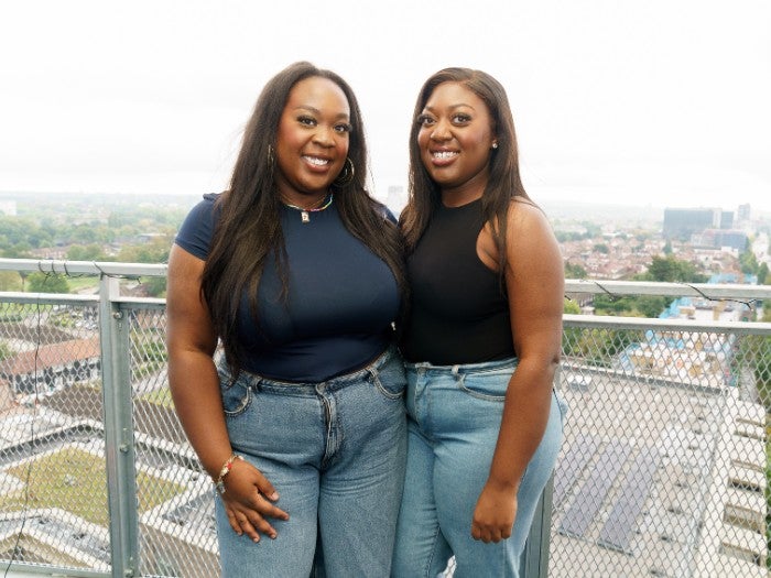 Baaba and Josephine pose for a photo on their ninth floor balcony overlooking Burnt Oak in London