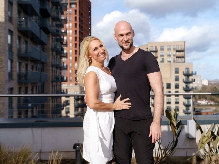 Domnita and Behjet pose for a picture in the shared gardens in their apartment block.