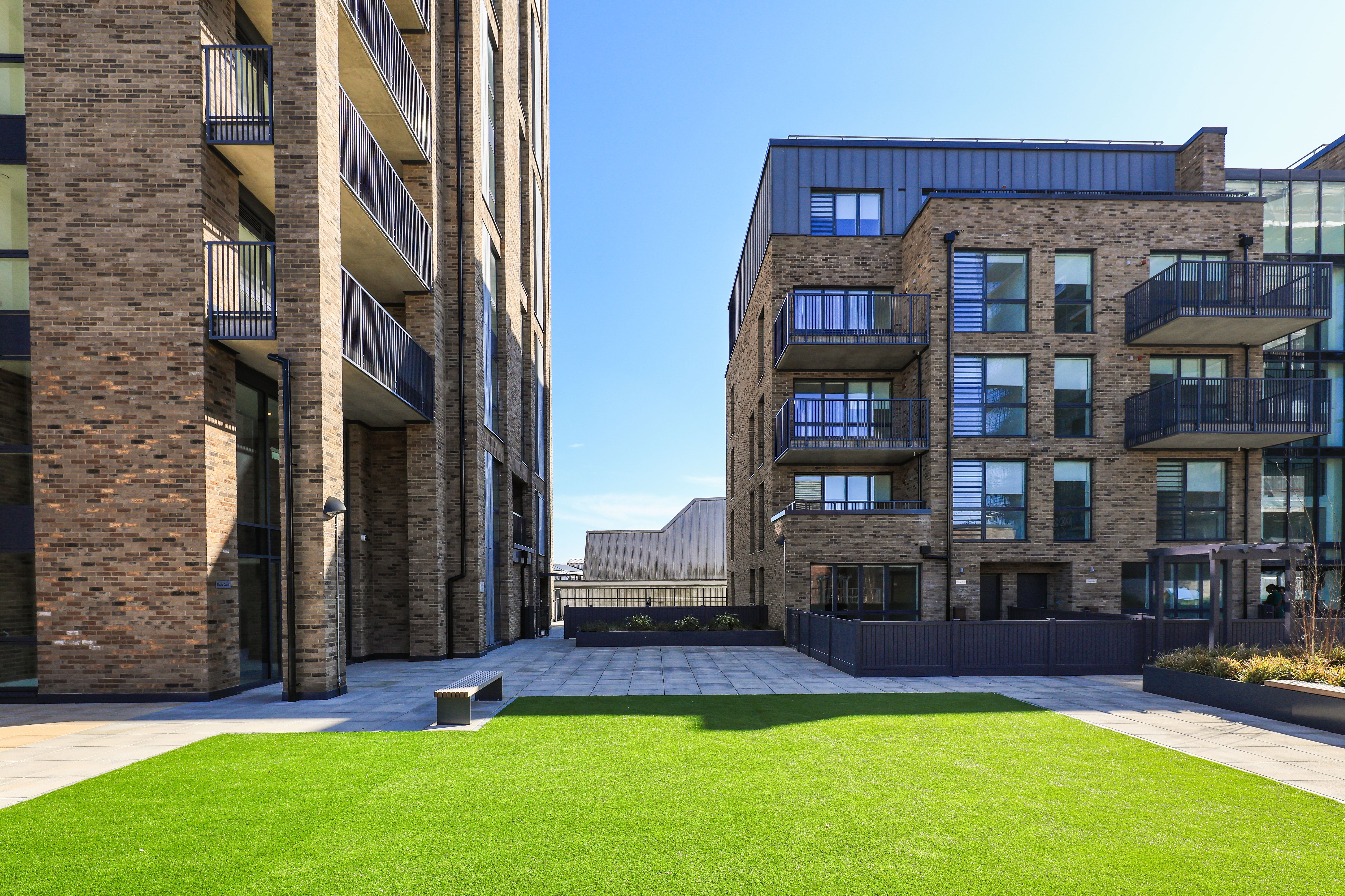 Landscape photograph of two apartment blocks and the shared rooftop garden at Edgware Parade