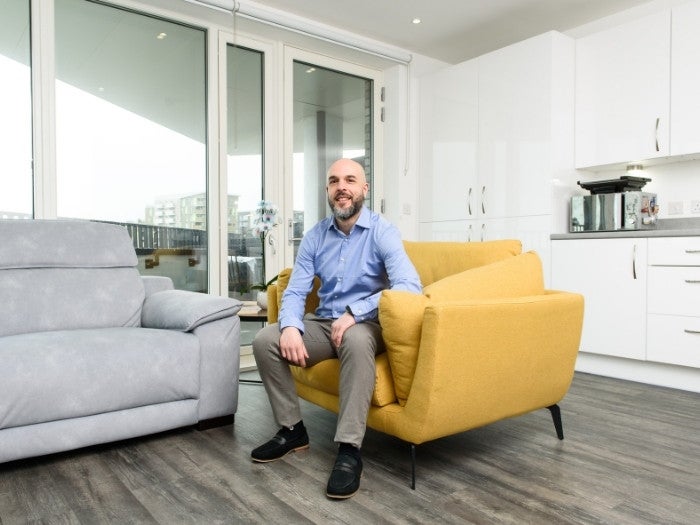 Daniel relaxes on a chair in his lounge