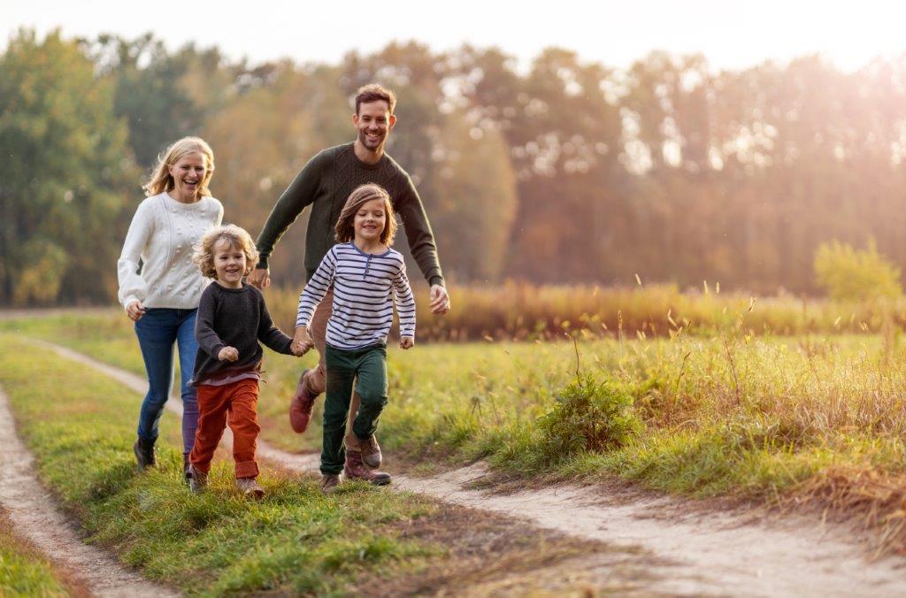 A young family walking in the country side.