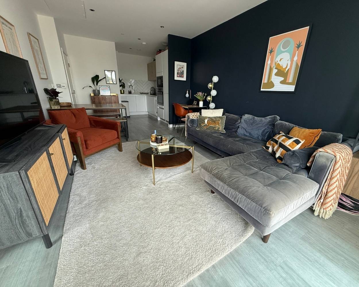 Photo of the spacious open-plan living space, showing the living, dining, desk and kitchen areas