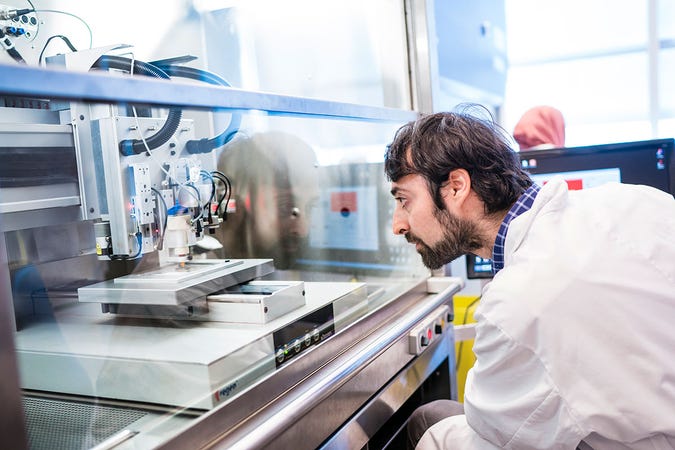 a male researcher inspecting medical equipment