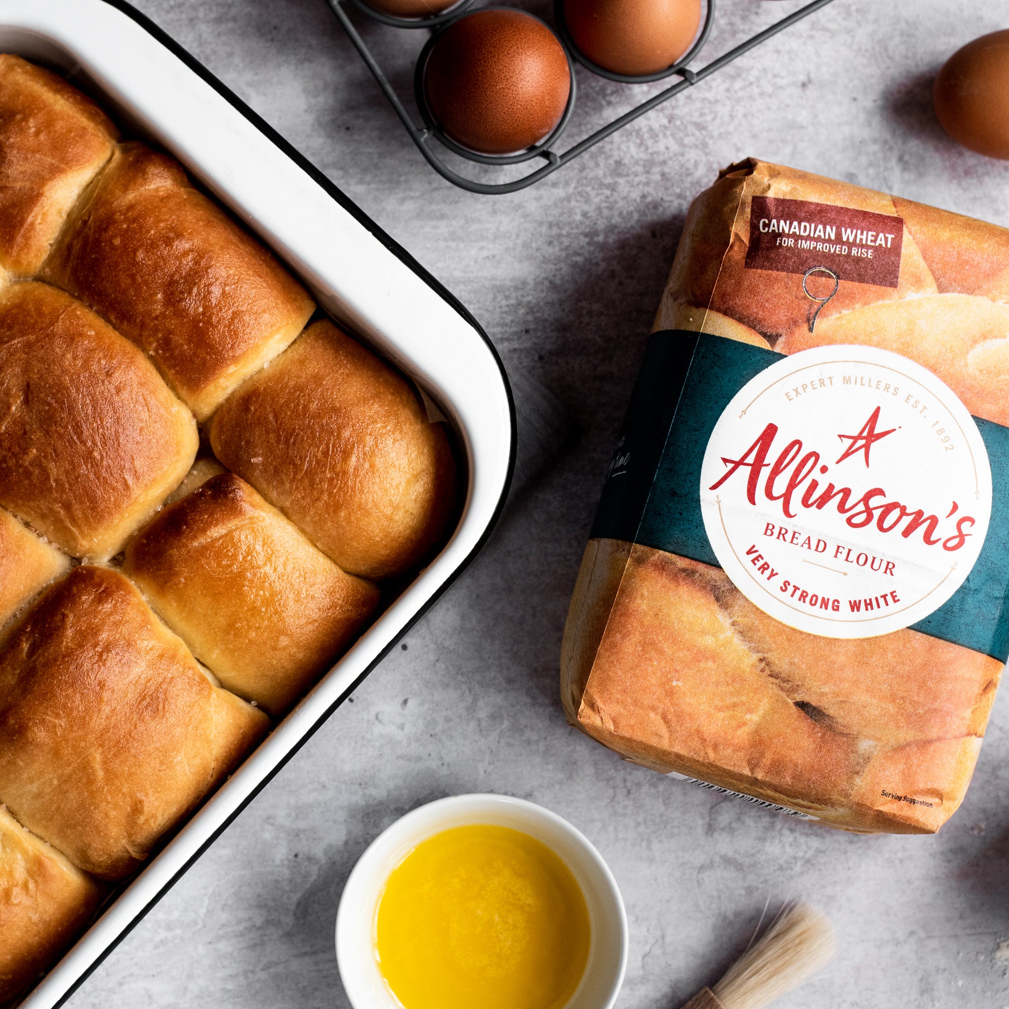 bread rolls in a tin with a side of melted butter and Allinson's bread flour