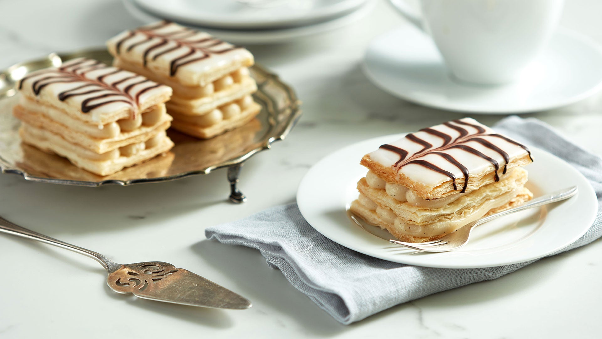 Mille-feuille is a three layers of French pastry dipped in vanilla cream.