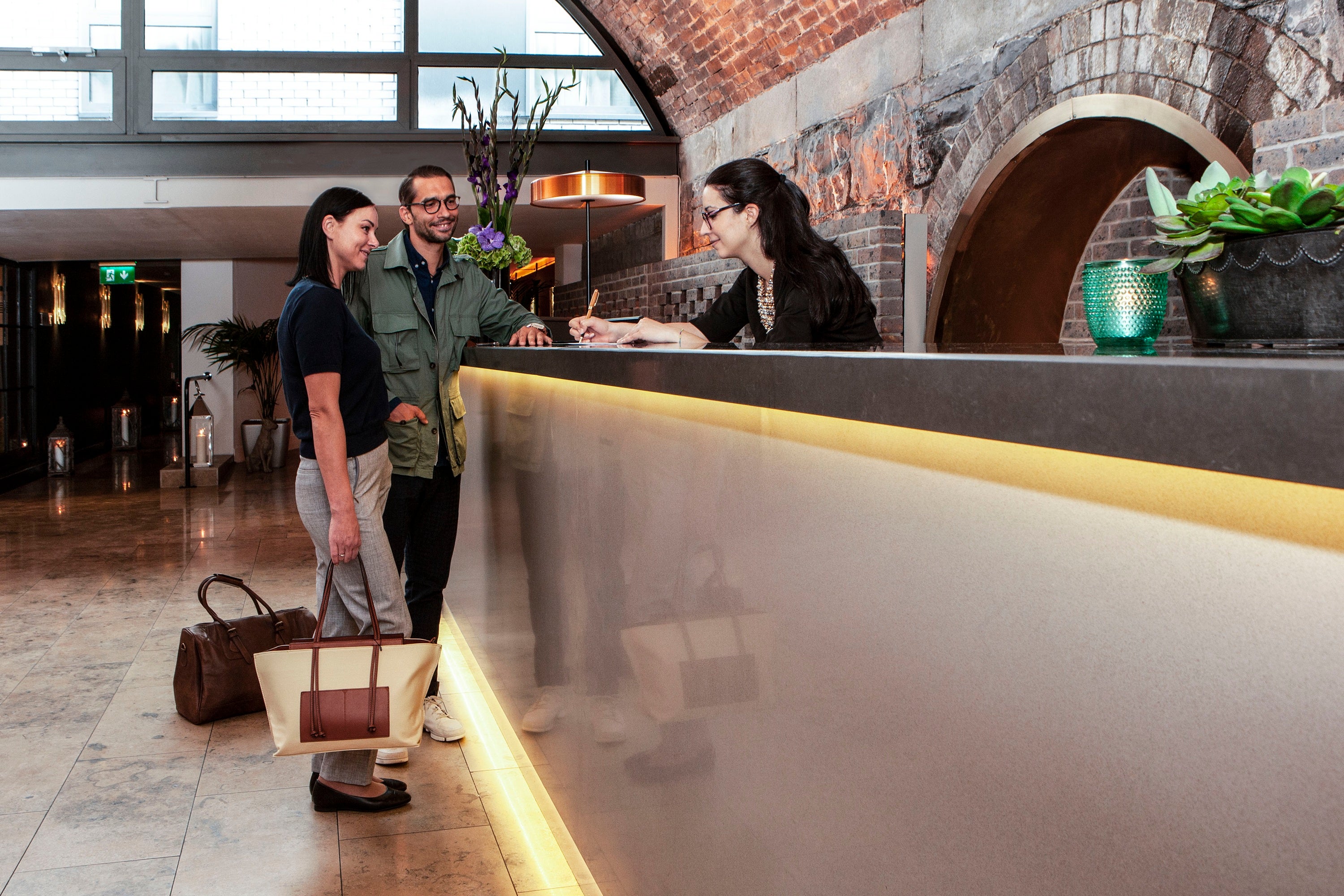 A group of people standing at a reception desk