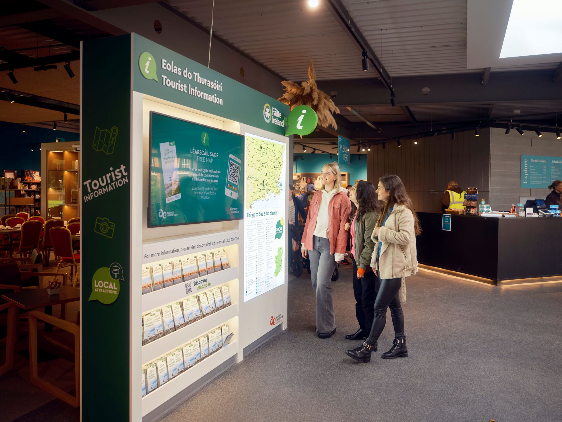 Visitors viewing information displays inside a tourist information centre