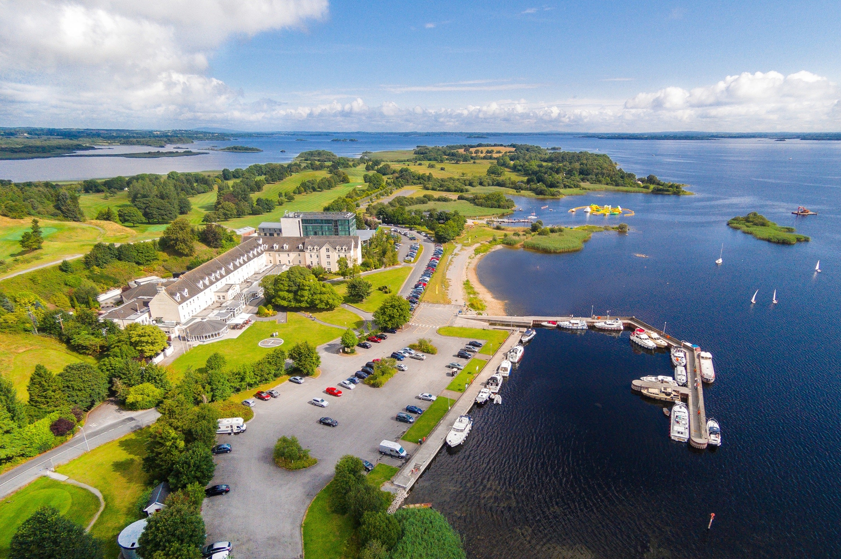 A aerial view of a body of water with a parking lot and boats