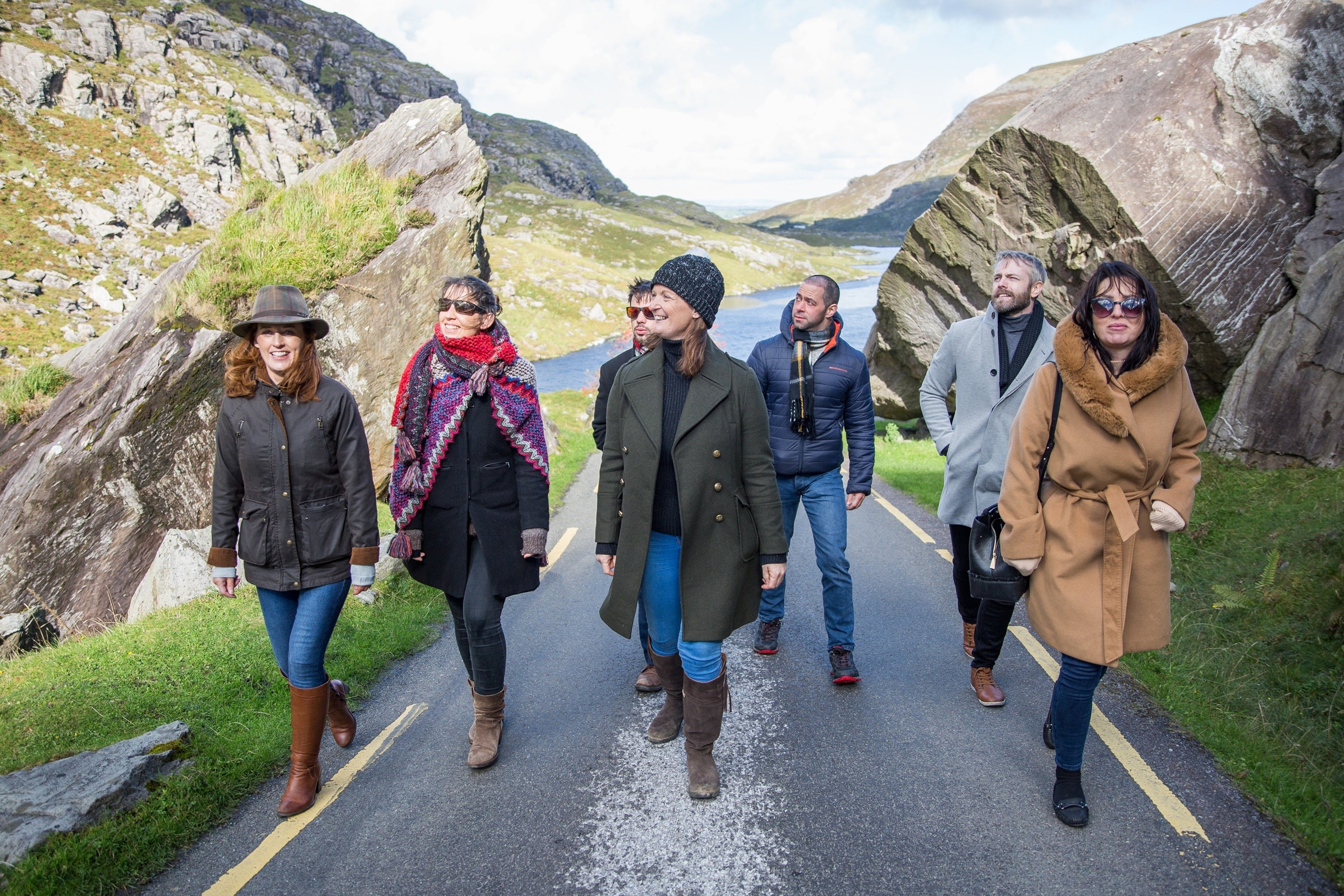 A group of people walking on a road