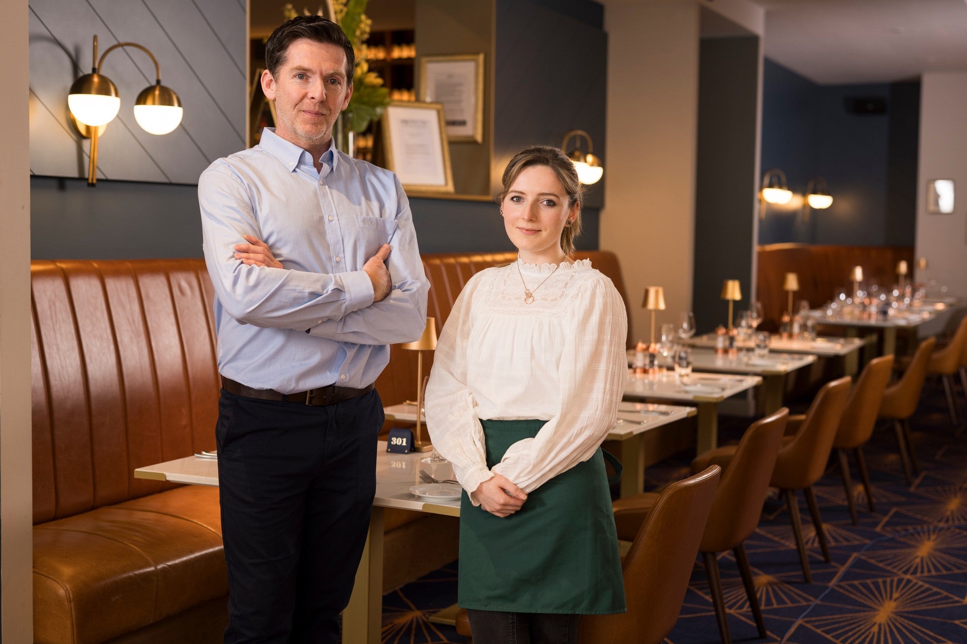 Restaurant staff standing together in a fine dining restaurant