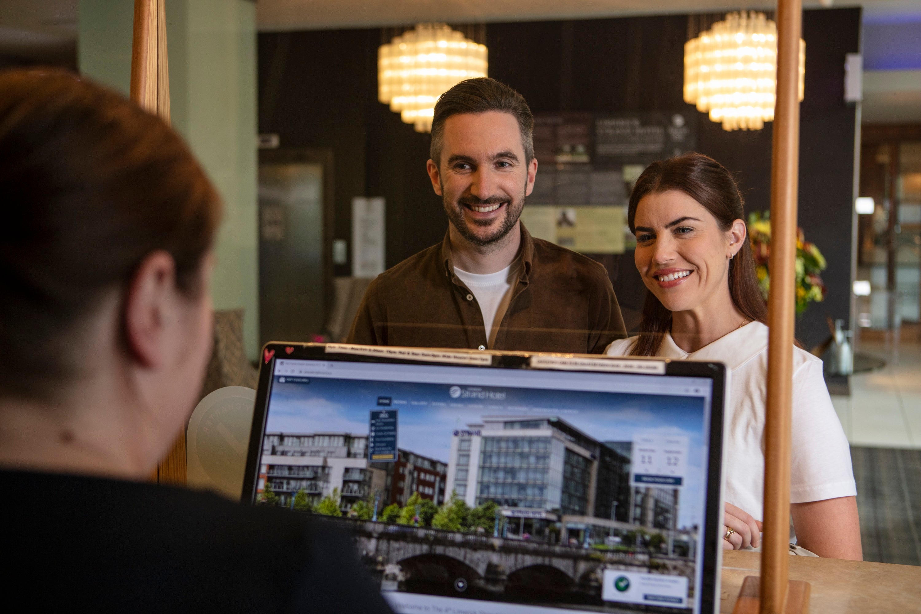 A man and woman looking at a laptop