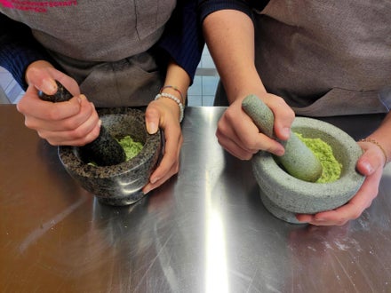 In zwei Mörsern werden verschiedene Kräuter zerkleinert