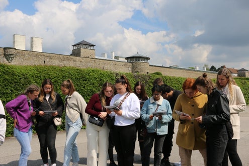 Schüler und Schülerinnen vor den Toren von Mauthausen