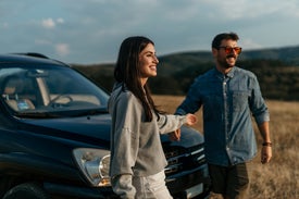 Muž a žena stojaci vedľa auta