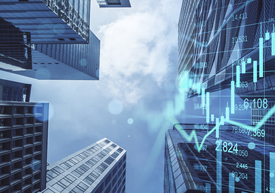 Looking up view of tall buildings with a graph and blue sky