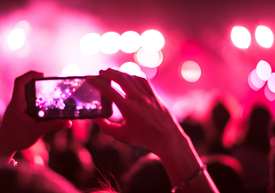 Egy mobiltelefont tartó személy kamerázik egy rendezvényen