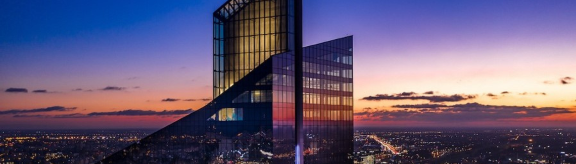 A tall building with a curved glass wall