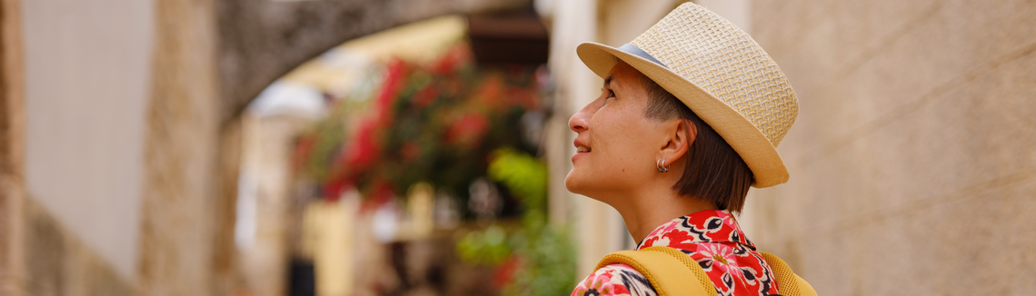 A woman wearing a hat and earrings