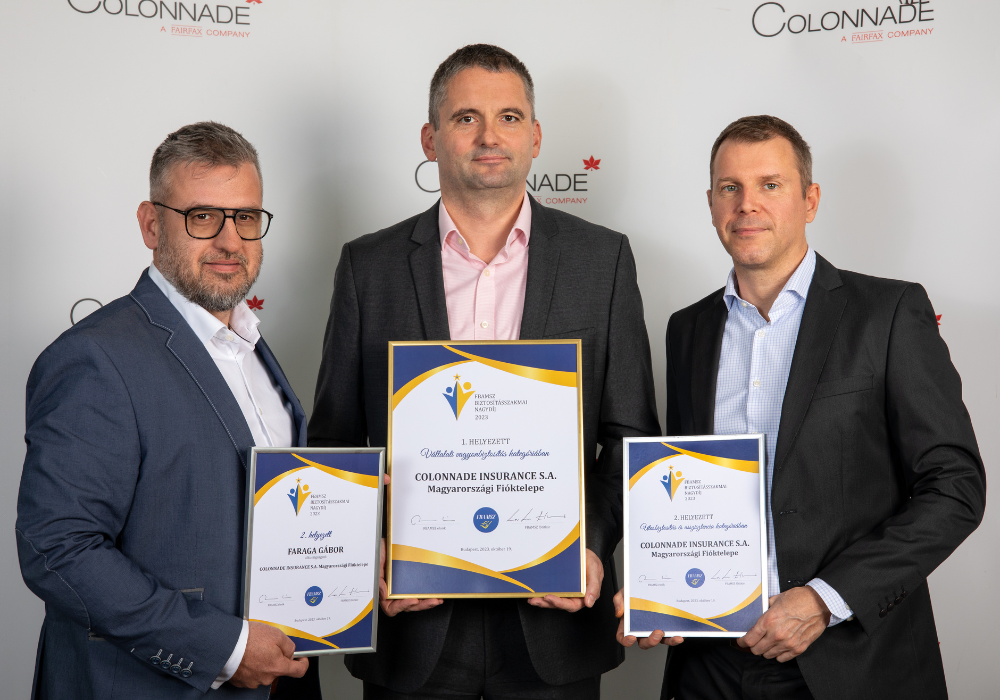 Egy csoport férfi, kezében oklevéllel