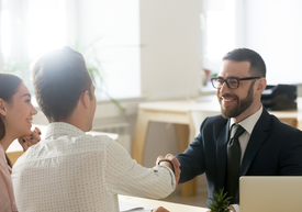 Two men shaking hands in an office