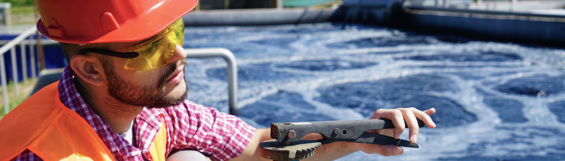 A person holding a metal object with a metal object in the back
