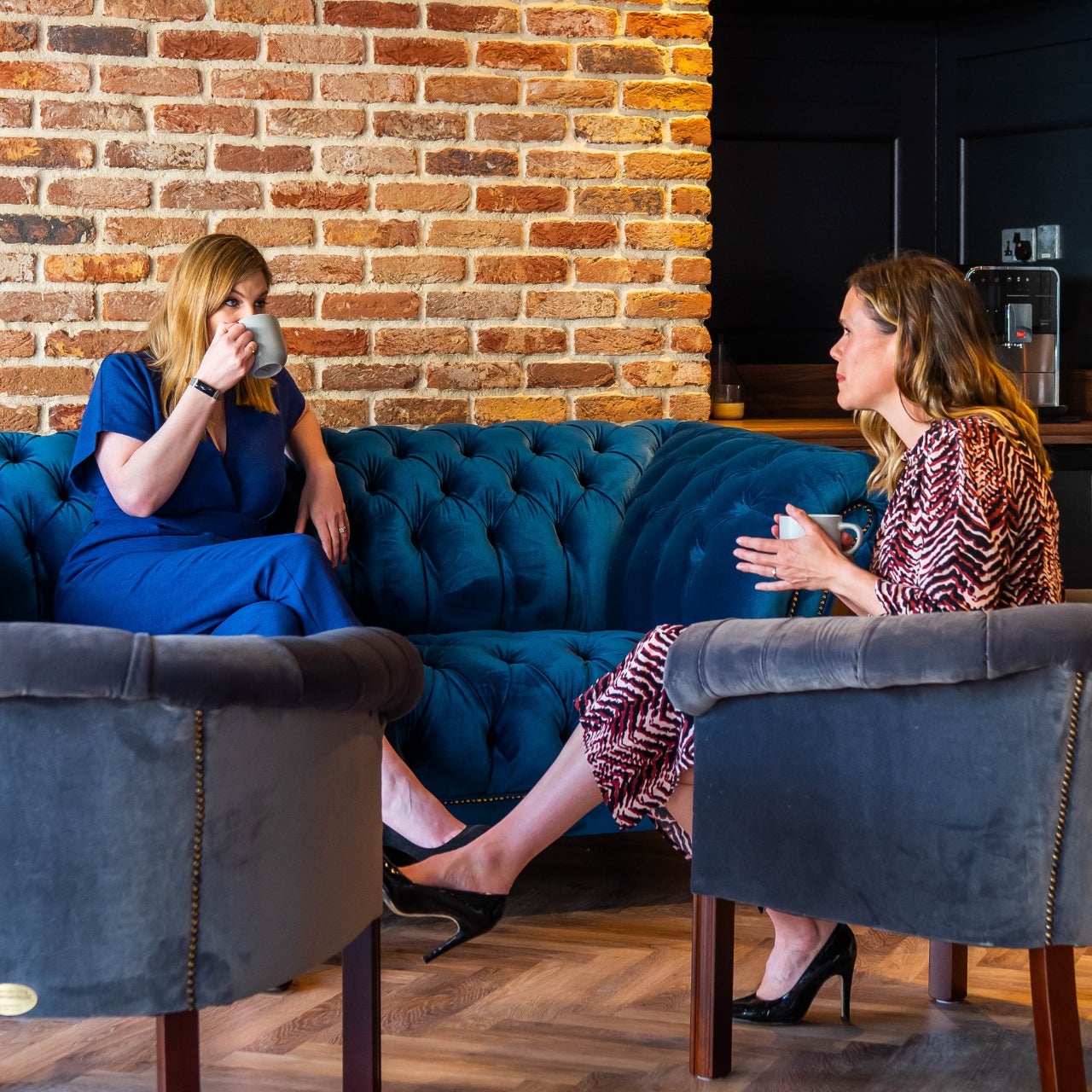 Max and Laura sitting in their Bicester office 