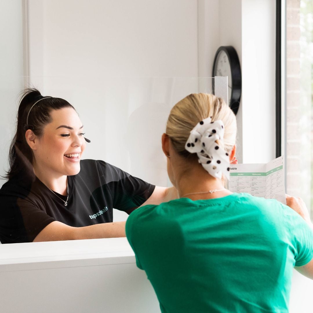 Receptionist showing a leaflet 