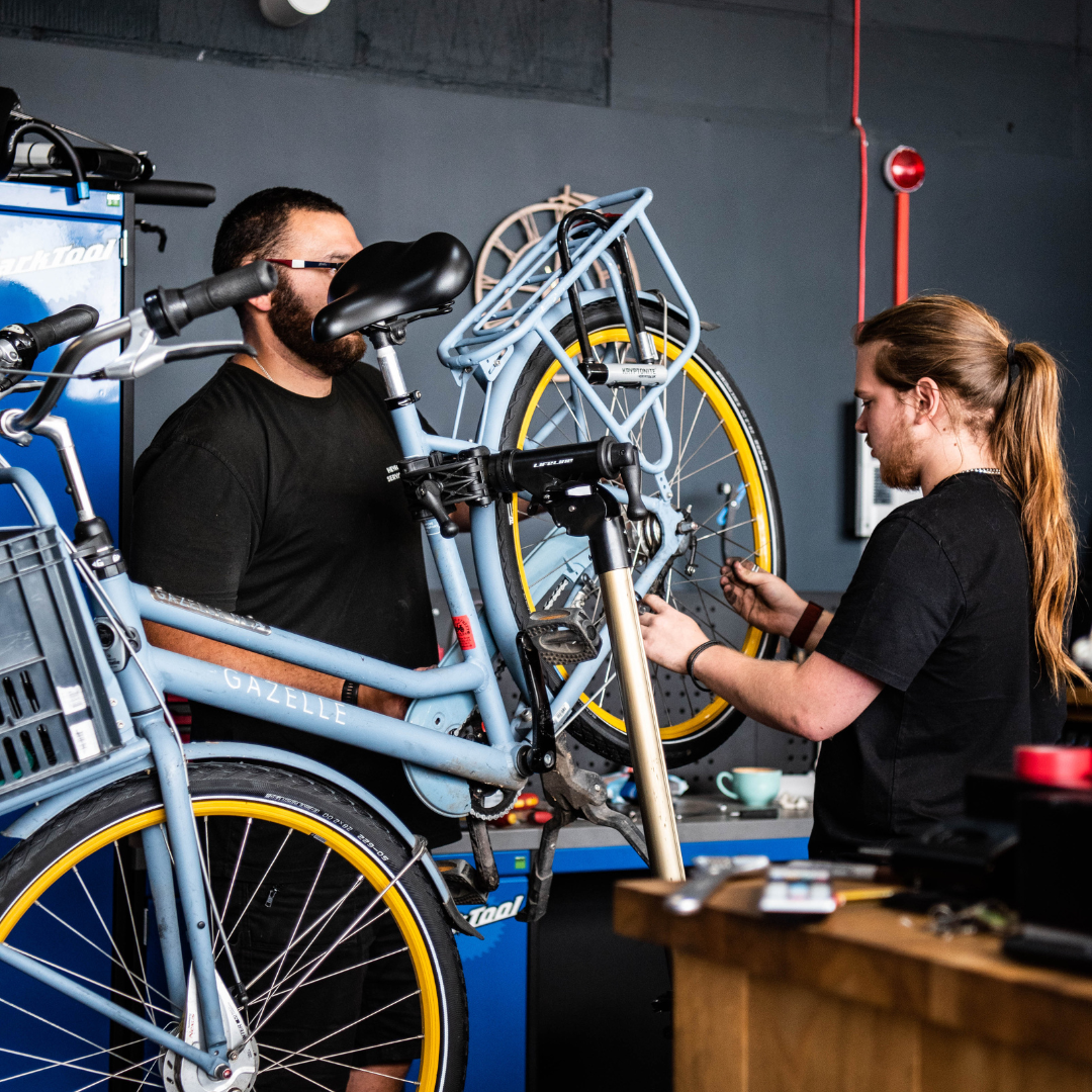 two people fixing a bike 