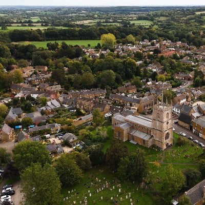 Aerial view of Chipping Norton, showing the historic town, church and surrounding North Cotswolds countryside.