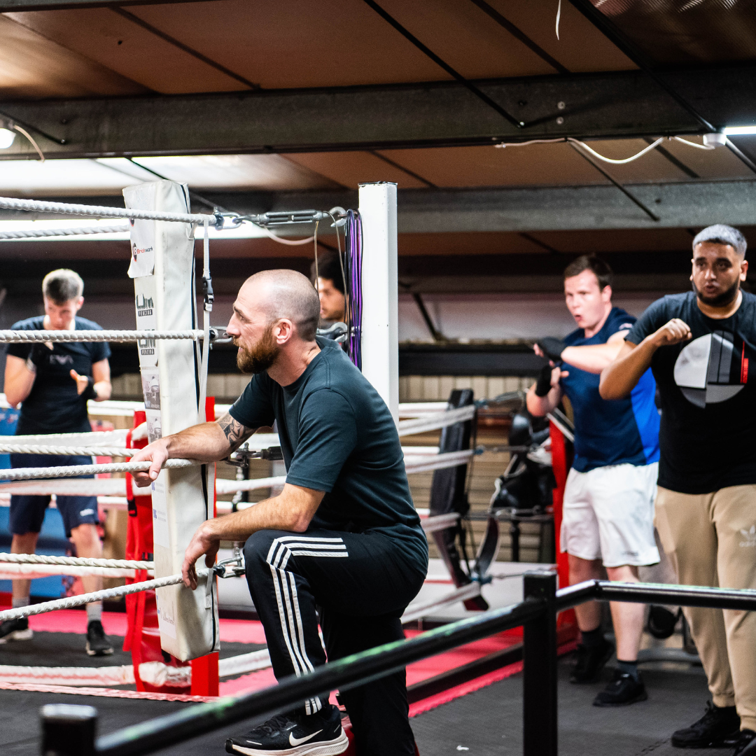 someone getting in the boxing ring 