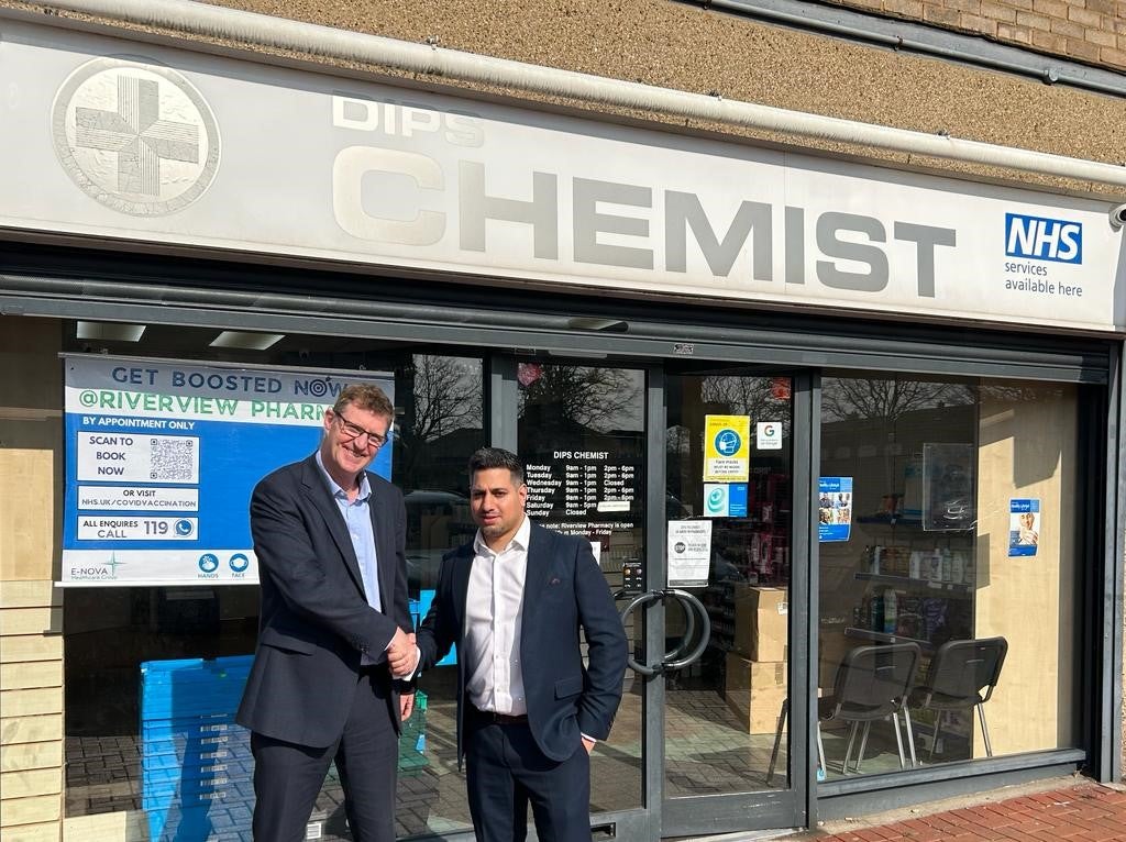 Mark Page from Christie & Co with the new owner outside Dips Chemist in Essex
