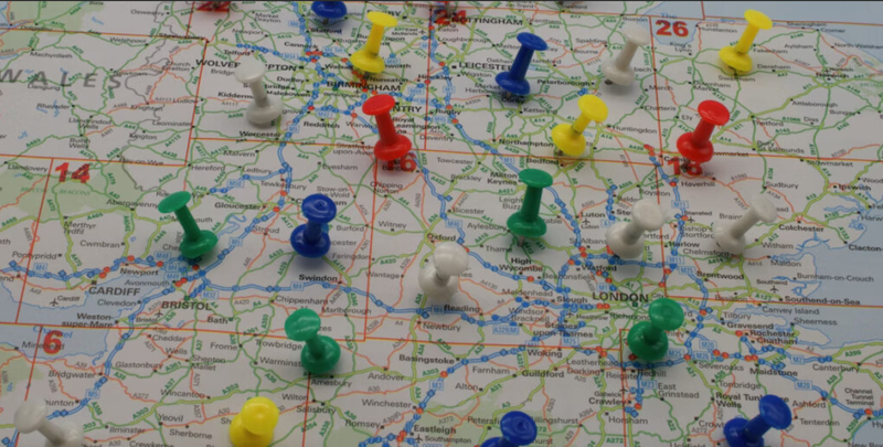 Coloured pins on a map of England, photo by Paul Marlow for Unsplash
