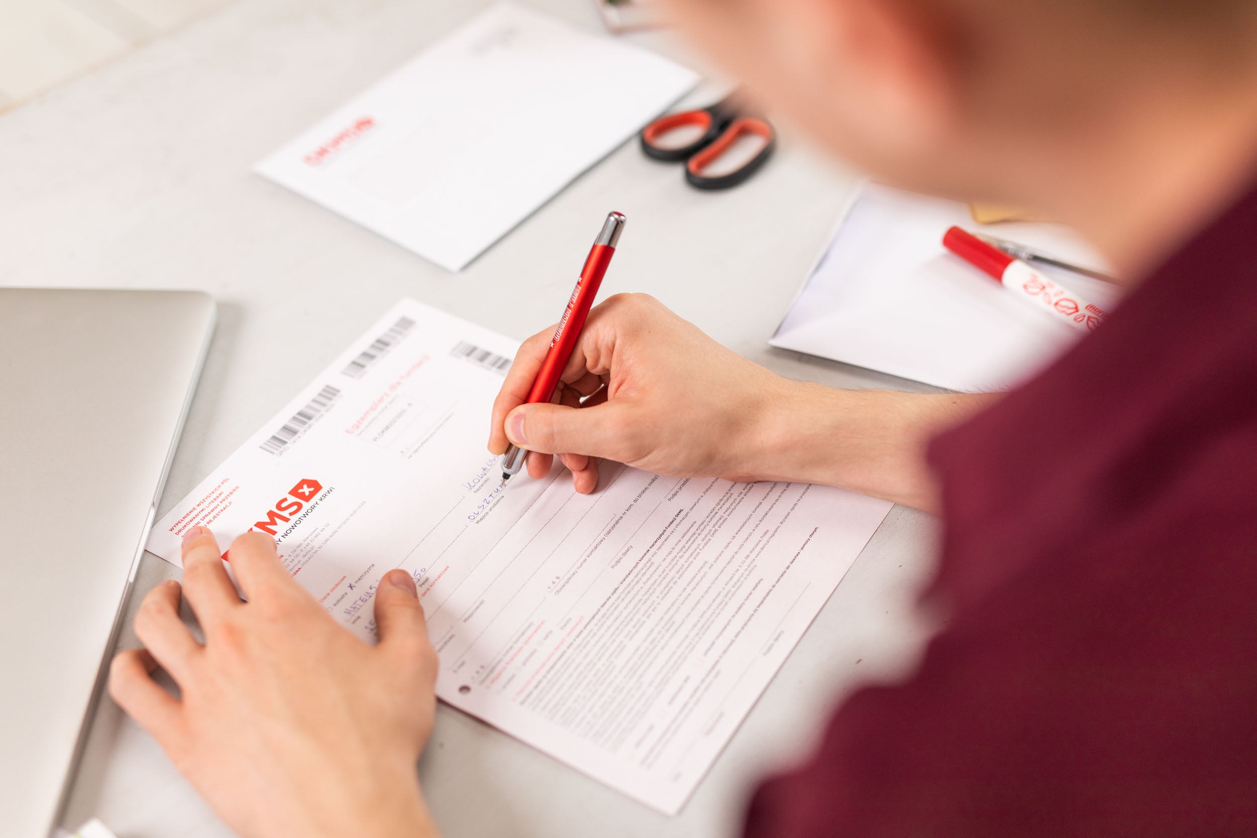 Eine Person, die auf ein Blatt Papier schreibt