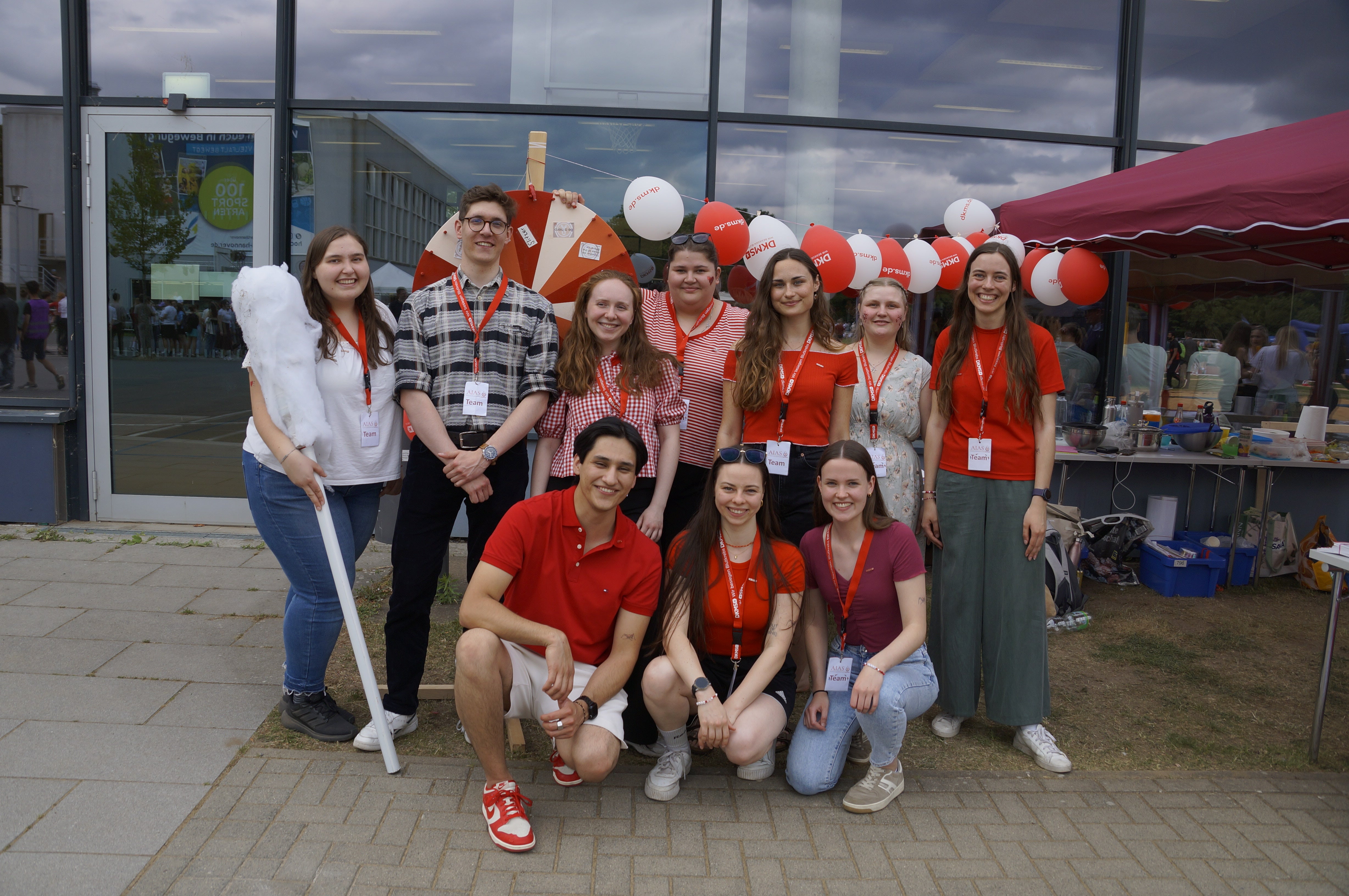 Mitglieder der AIAS-Gruppe Hannover stehen vor einem DKMS-Registrierungsstand.