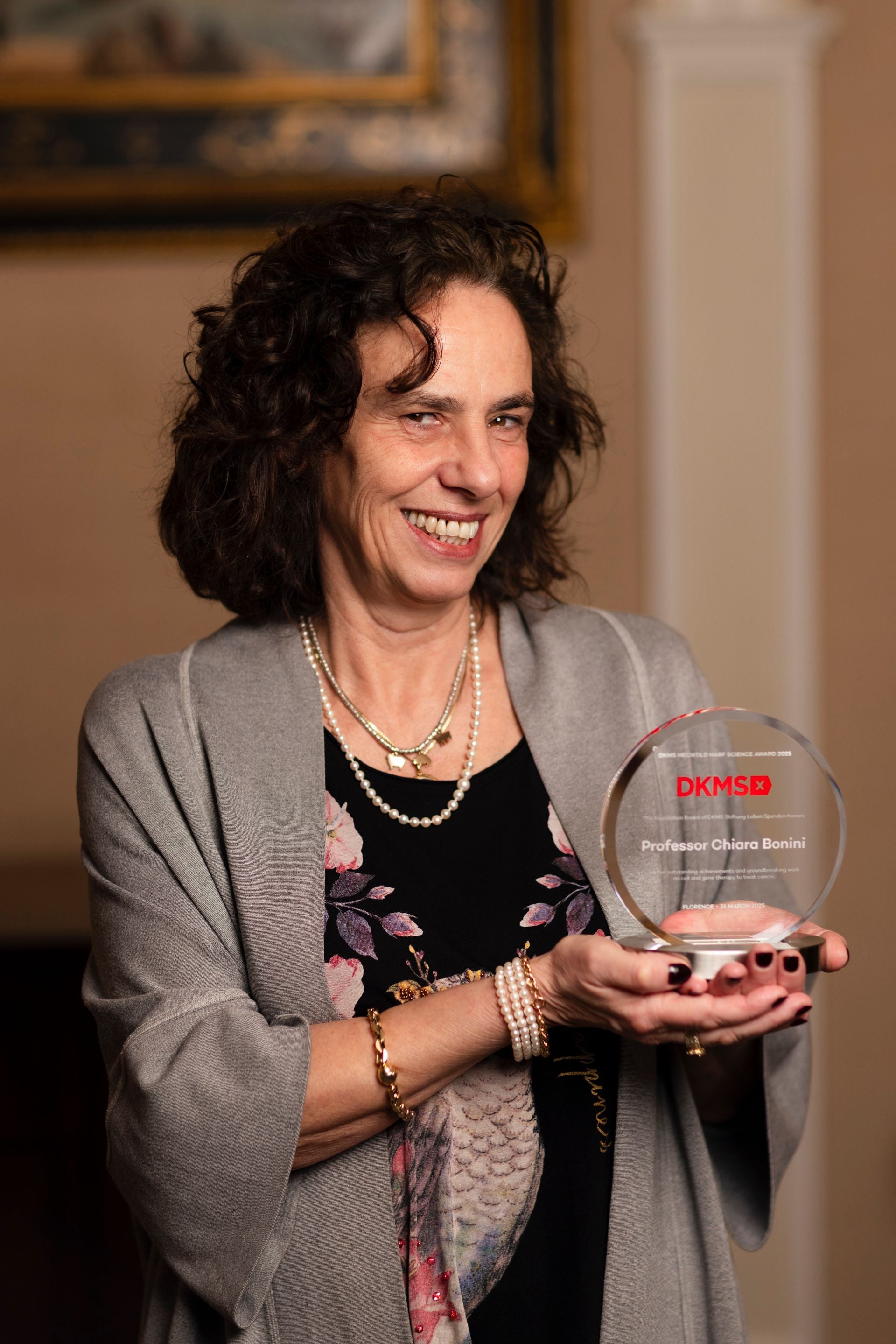 A women with dark hairs is presenting her science award 