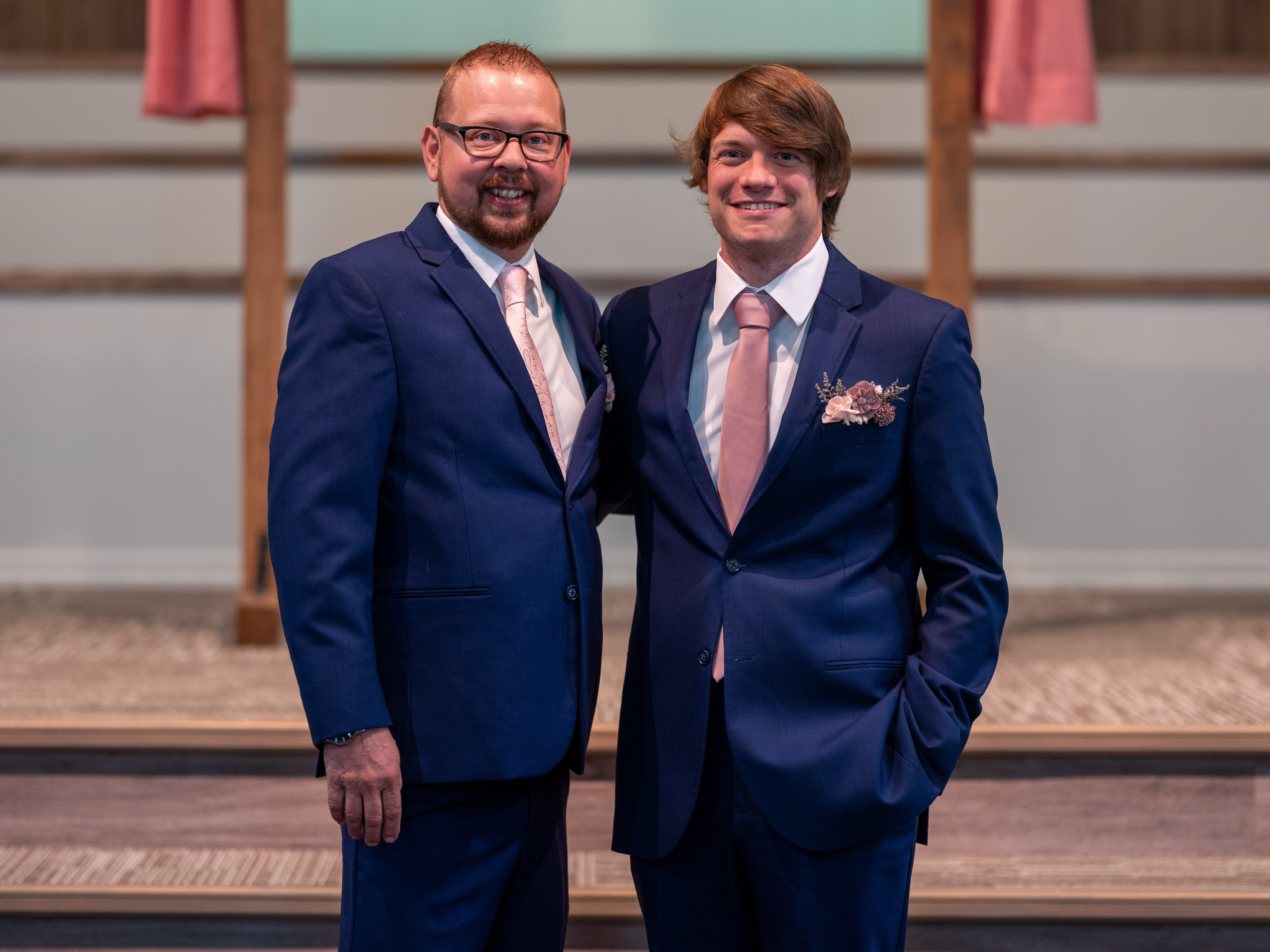 zwei Männer im Anzug posieren für ein Foto