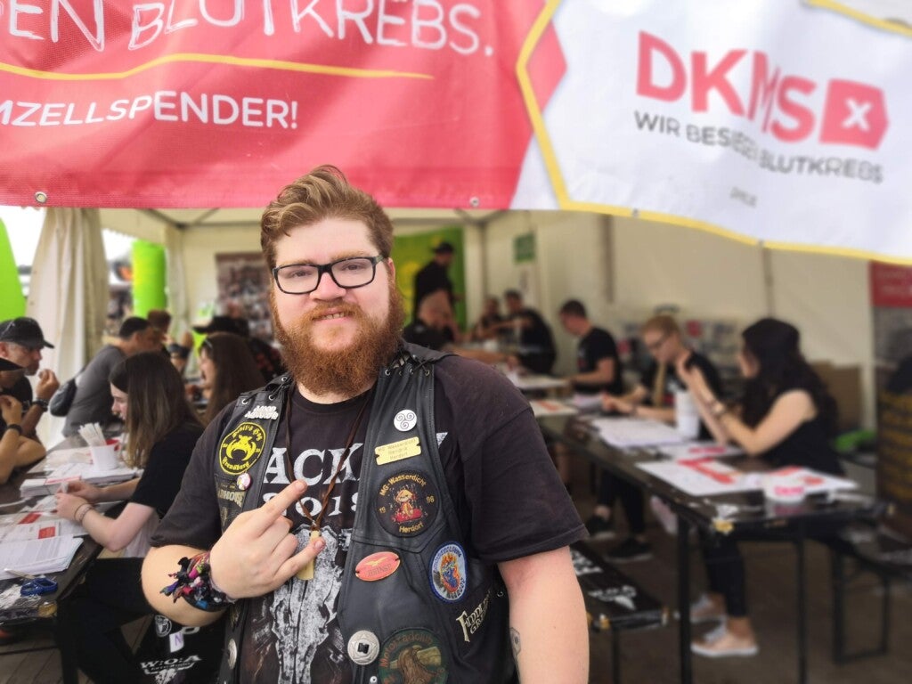 Ein Mann mit einem Bart und einer schwarzen Weste mit Patches darauf