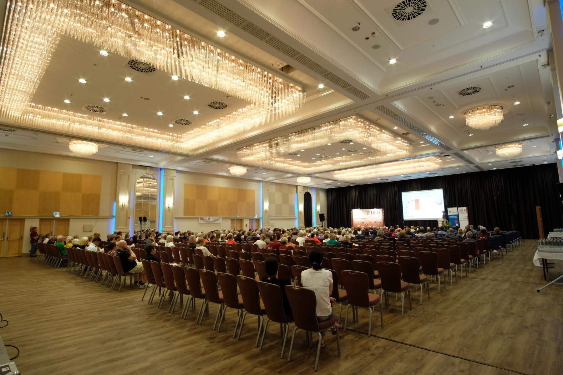 Ein großer Raum mit vielen Stühlen und einer Bühne