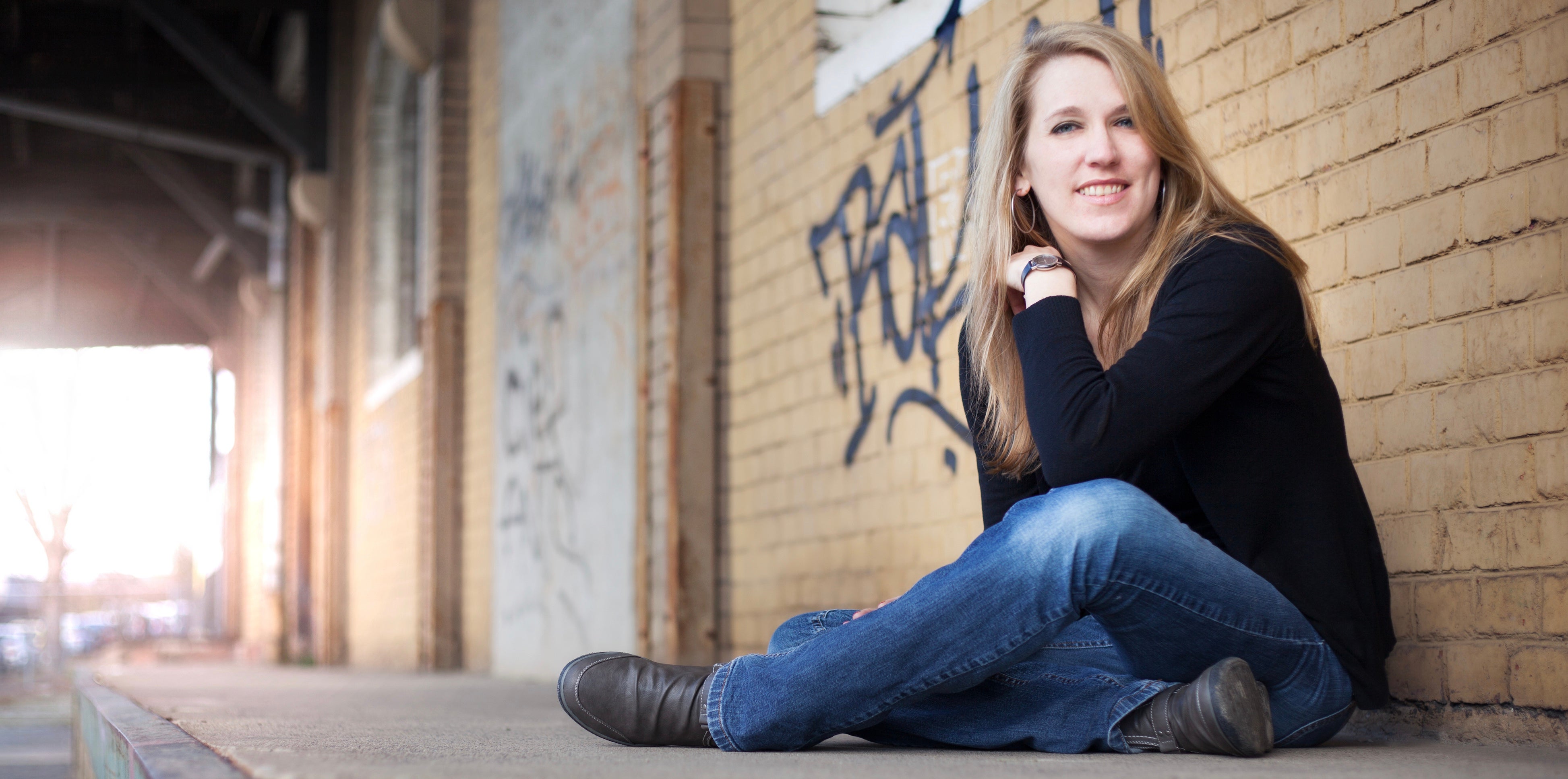 Mara Pfeiffer sitzt auf dem Boden und posiert für die Kamera 